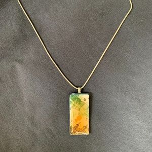 Silver necklace with rectangle pendant depicting scenes of England